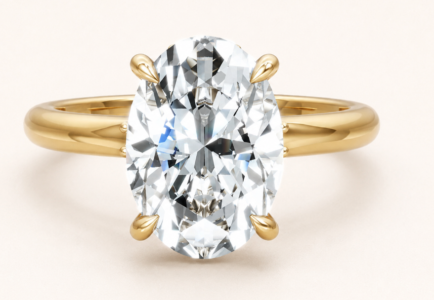 An oval-cut diamond engagement ring with a yellow gold band, set against a clean, light beige background.